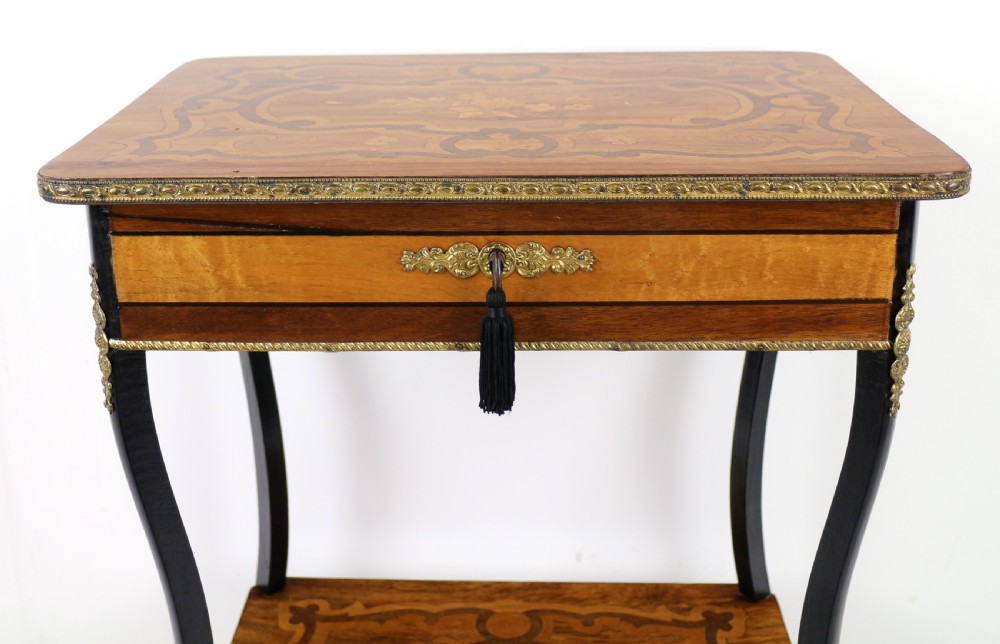 A late 19th-century French Napoleon III work table featuring floral marquetry inlays, ebonised legs, a single lockable drawer, and a lower shelf with brass mouldings. View VII