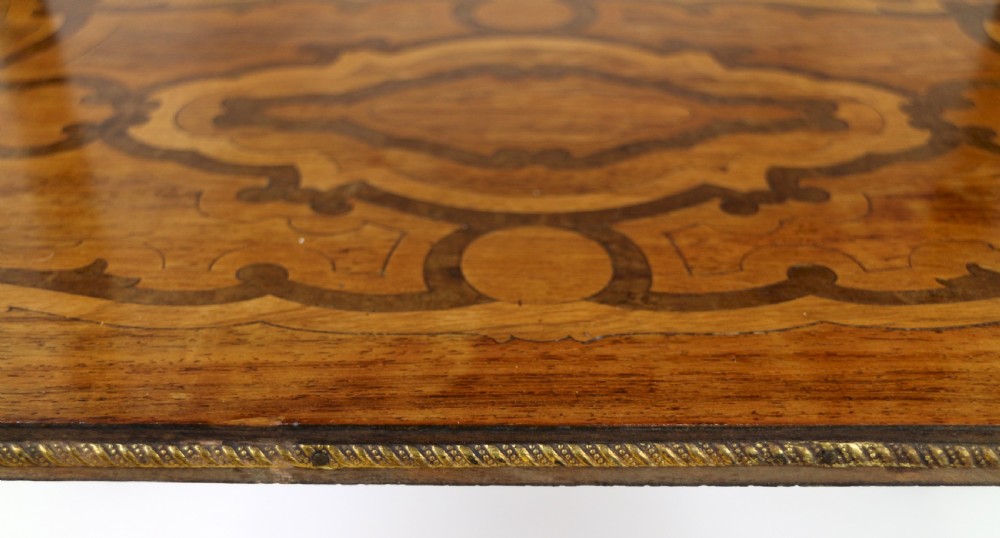 A late 19th-century French Napoleon III work table featuring floral marquetry inlays, ebonised legs, a single lockable drawer, and a lower shelf with brass mouldings. View X