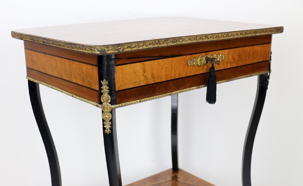 A late 19th-century French Napoleon III work table featuring floral marquetry inlays, ebonised legs, a single lockable drawer, and a lower shelf with brass mouldings. View XII