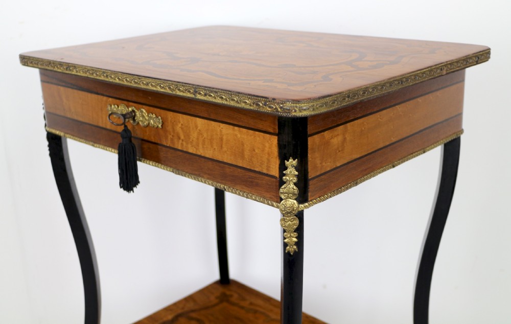 A late 19th-century French Napoleon III work table featuring floral marquetry inlays, ebonised legs, a single lockable drawer, and a lower shelf with brass mouldings. View XV