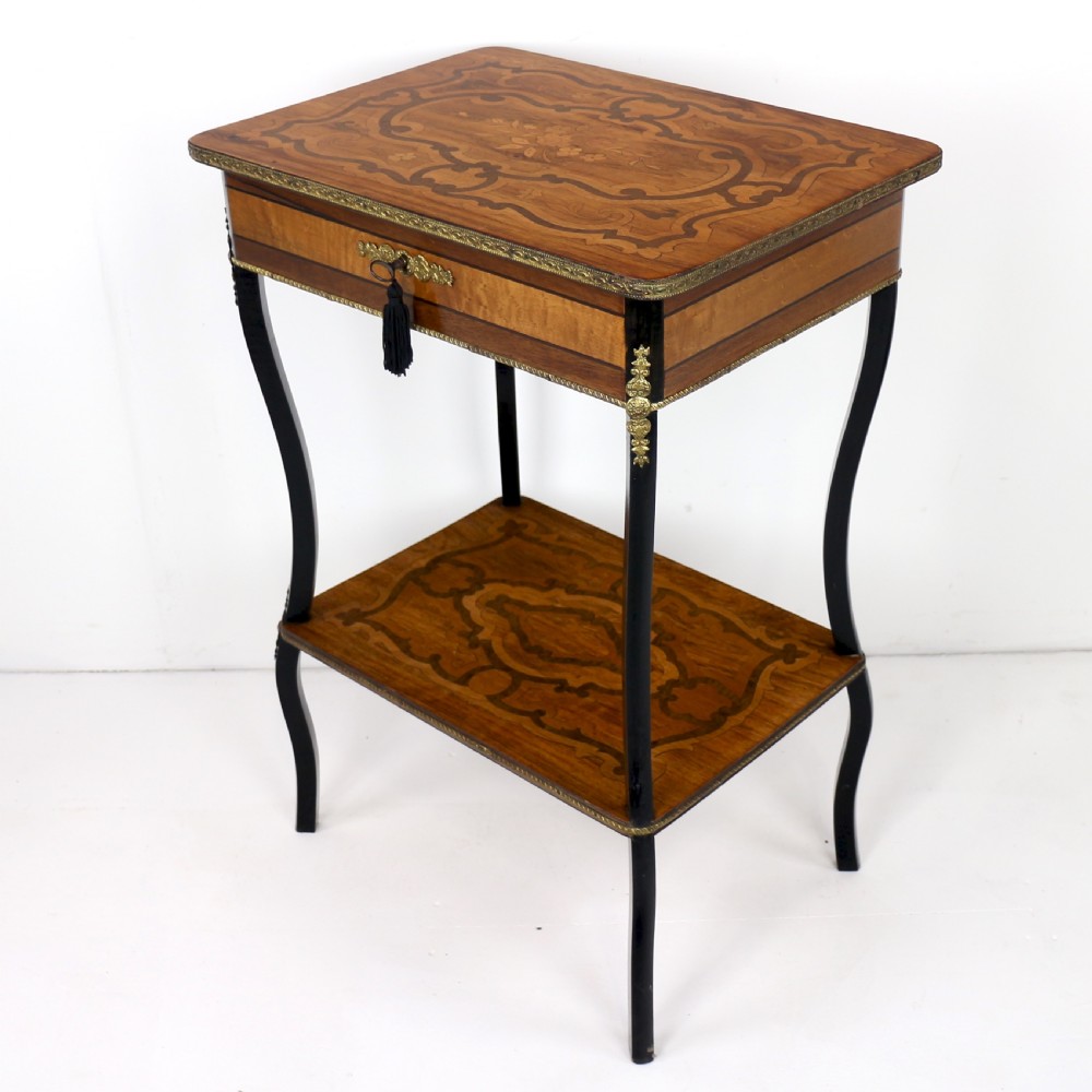 A late 19th-century French Napoleon III work table featuring floral marquetry inlays, ebonised legs, a single lockable drawer, and a lower shelf with brass mouldings. View XVII