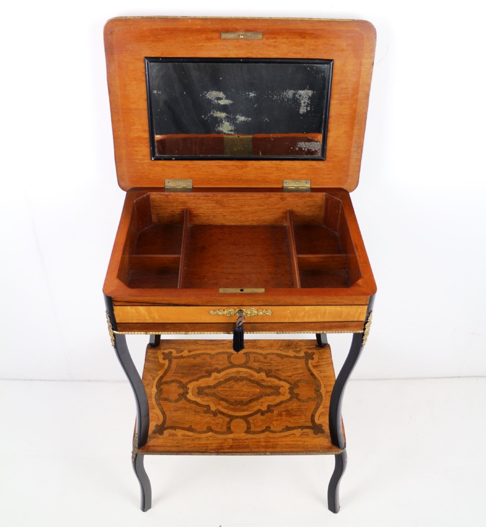 A late 19th-century French Napoleon III work table featuring floral marquetry inlays, ebonised legs, a single lockable drawer, and a lower shelf with brass mouldings. View XIX