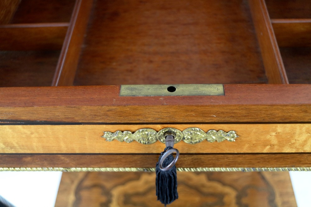 A late 19th-century French Napoleon III work table featuring floral marquetry inlays, ebonised legs, a single lockable drawer, and a lower shelf with brass mouldings. View XXII