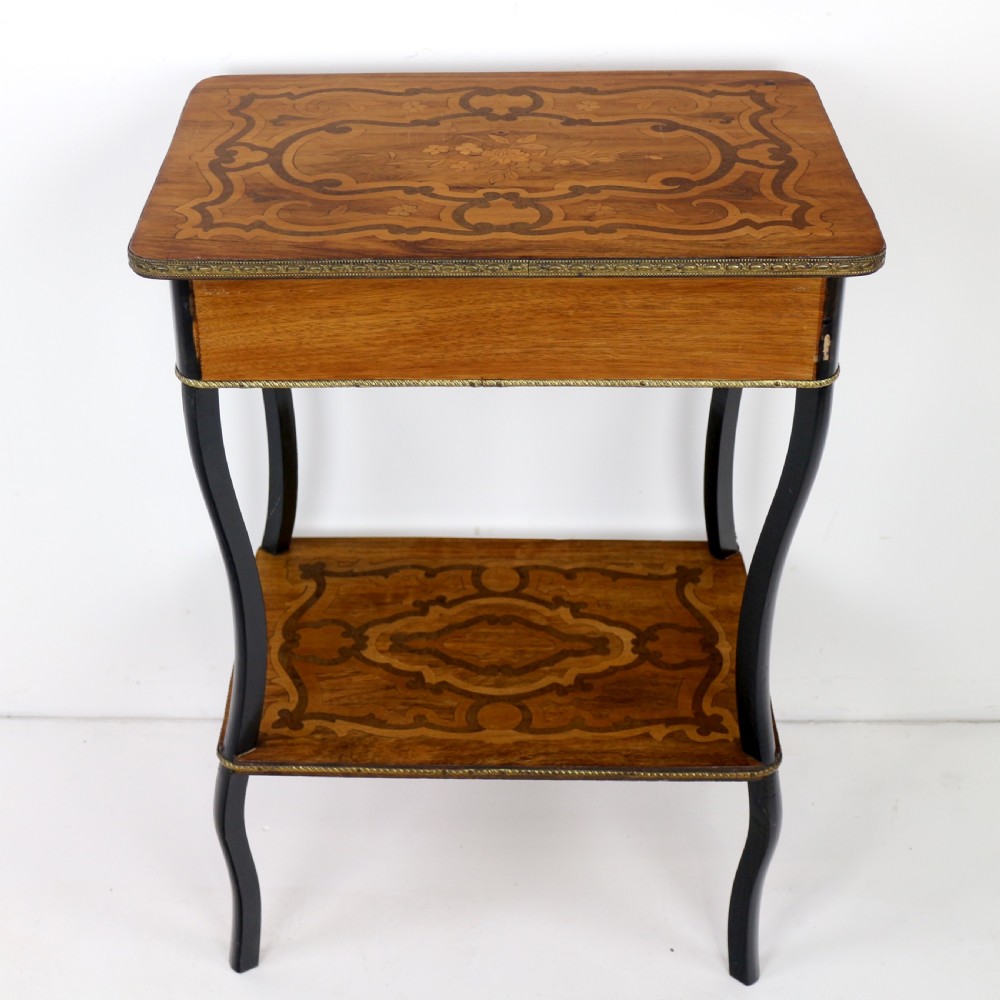 A late 19th-century French Napoleon III work table featuring floral marquetry inlays, ebonised legs, a single lockable drawer, and a lower shelf with brass mouldings. View XXIV