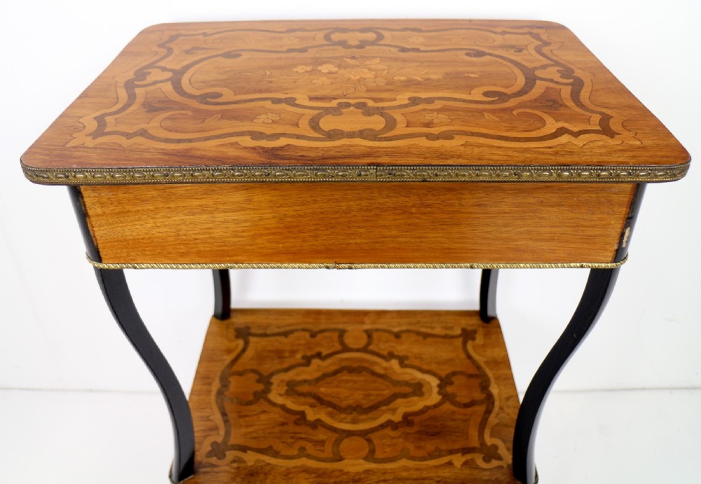 A late 19th-century French Napoleon III work table featuring floral marquetry inlays, ebonised legs, a single lockable drawer, and a lower shelf with brass mouldings. View XXV