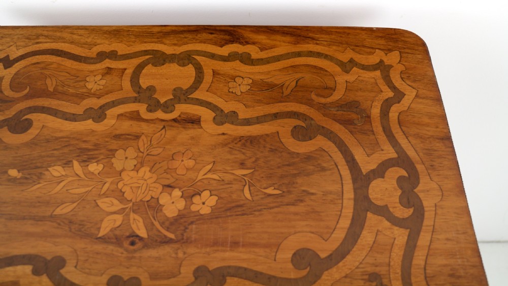 A late 19th-century French Napoleon III work table featuring floral marquetry inlays, ebonised legs, a single lockable drawer, and a lower shelf with brass mouldings. View XXVI