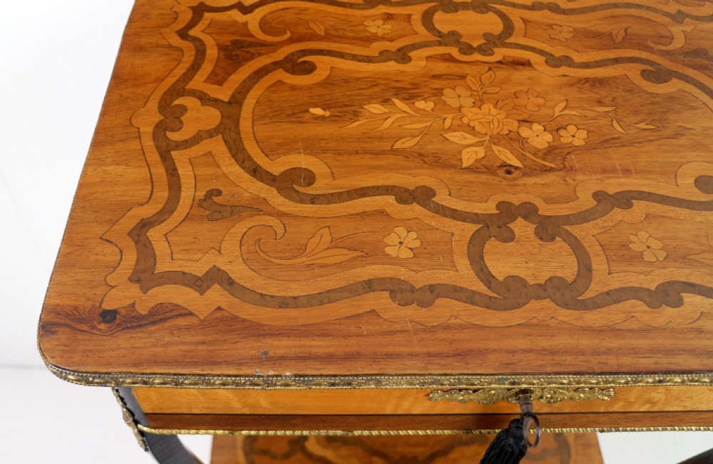A late 19th-century French Napoleon III work table featuring floral marquetry inlays, ebonised legs, a single lockable drawer, and a lower shelf with brass mouldings. View XXVII