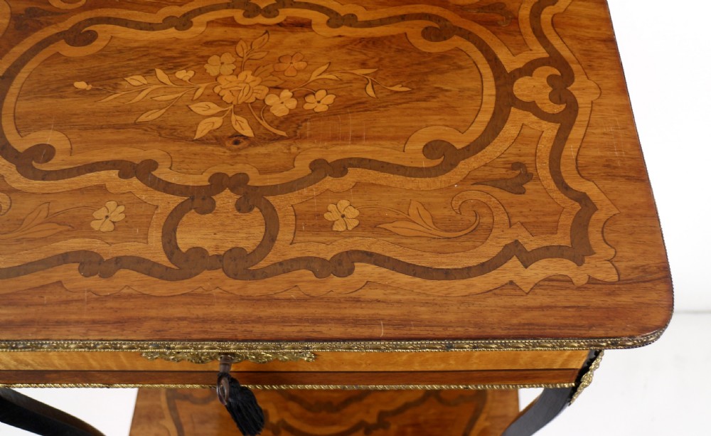 A late 19th-century French Napoleon III work table featuring floral marquetry inlays, ebonised legs, a single lockable drawer, and a lower shelf with brass mouldings. View XXVIII
