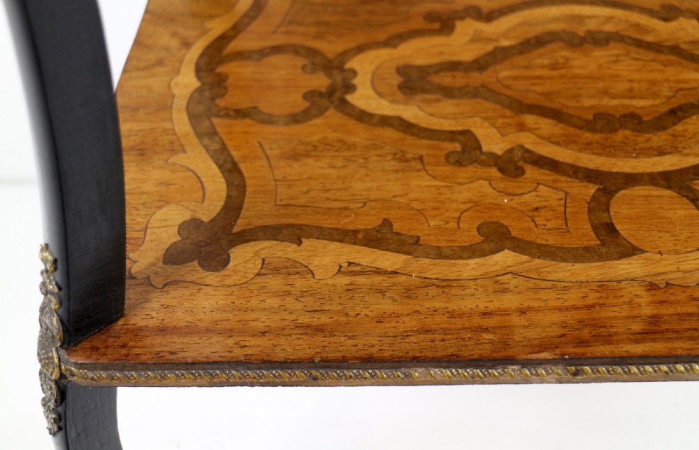 A late 19th-century French Napoleon III work table featuring floral marquetry inlays, ebonised legs, a single lockable drawer, and a lower shelf with brass mouldings. View XXX
