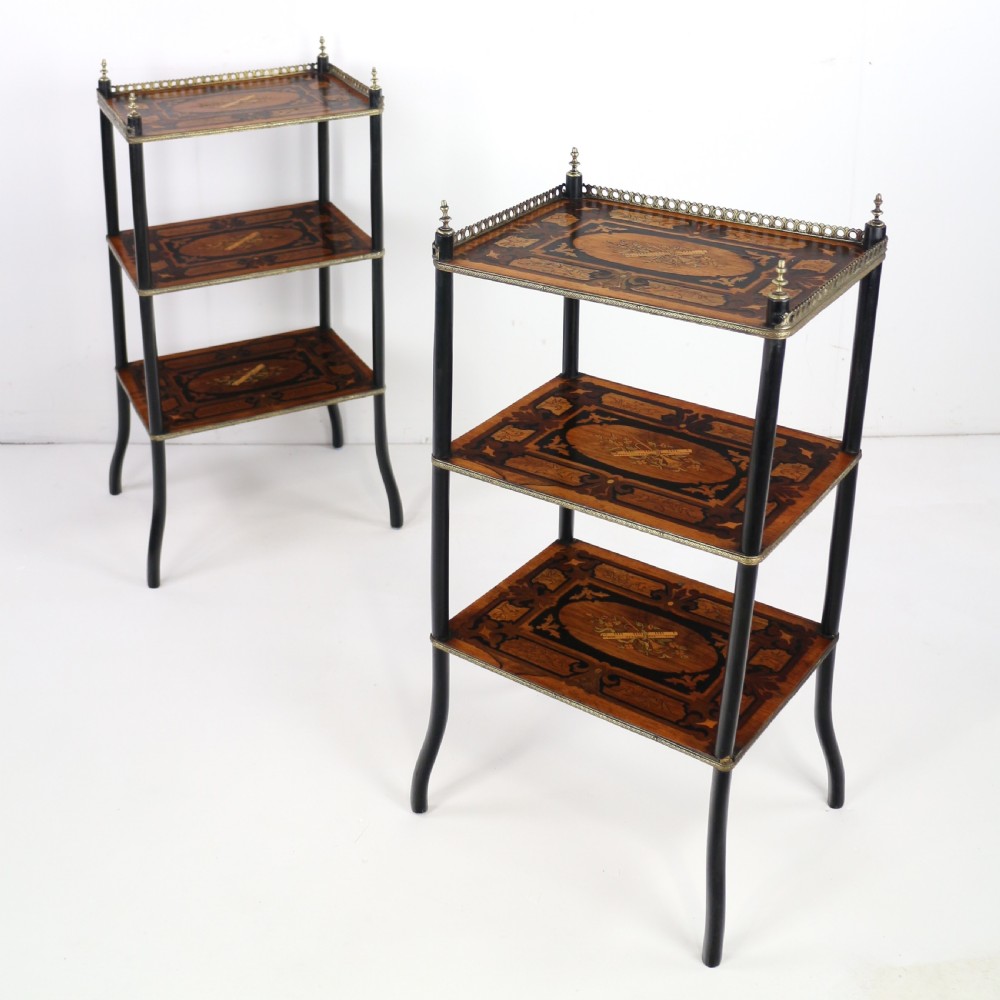A pair of 19th-century French three-tier etageres featuring inlaid wood marquetry designs, ebonised legs, and pierced brass galleries on top. View II