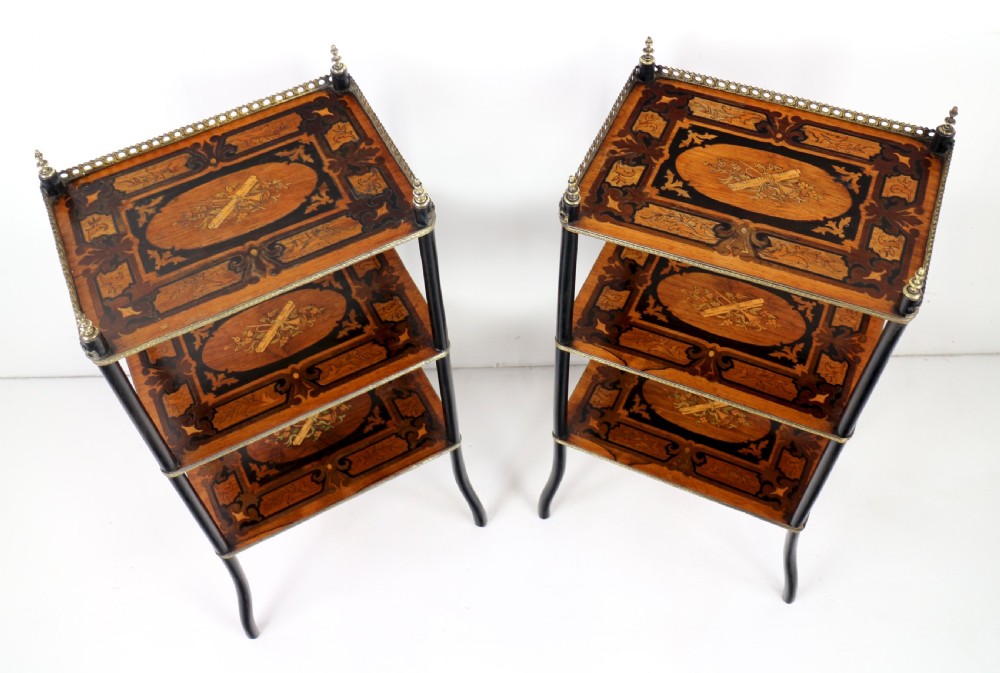 A pair of 19th-century French three-tier etageres featuring inlaid wood marquetry designs, ebonised legs, and pierced brass galleries on top. View V