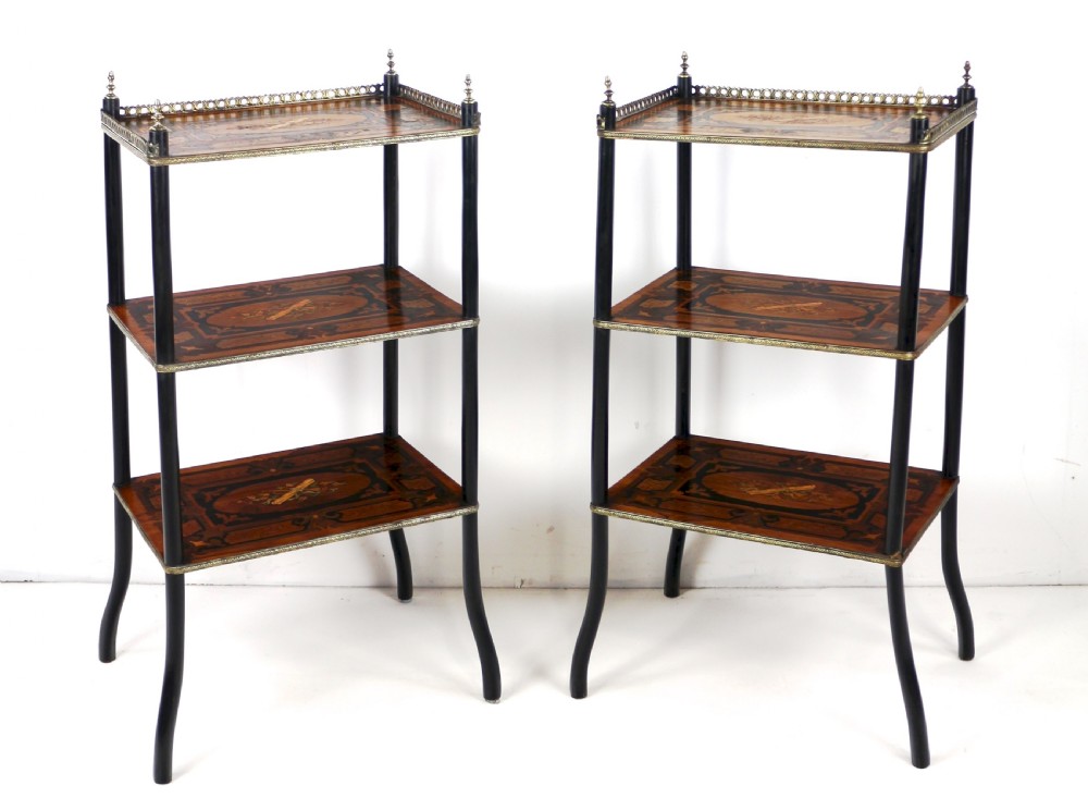A pair of 19th-century French three-tier etageres featuring inlaid wood marquetry designs, ebonised legs, and pierced brass galleries on top. View VI