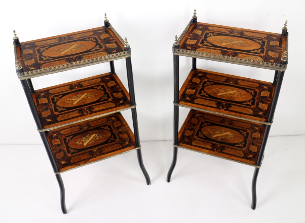 A pair of 19th-century French three-tier etageres featuring inlaid wood marquetry designs, ebonised legs, and pierced brass galleries on top. View IX