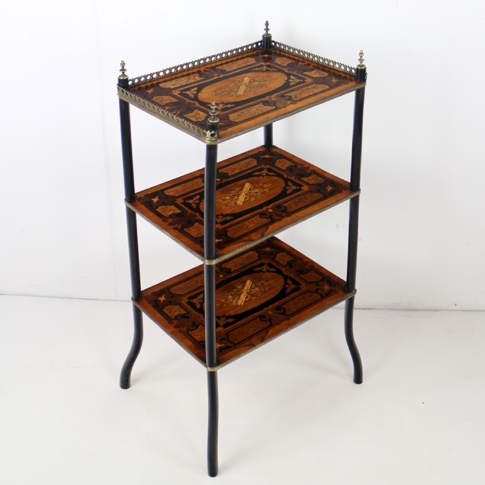 A pair of 19th-century French three-tier etageres featuring inlaid wood marquetry designs, ebonised legs, and pierced brass galleries on top. View XI