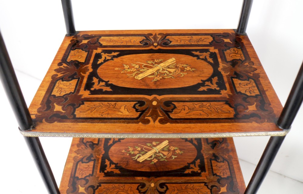 A pair of 19th-century French three-tier etageres featuring inlaid wood marquetry designs, ebonised legs, and pierced brass galleries on top. View XIV