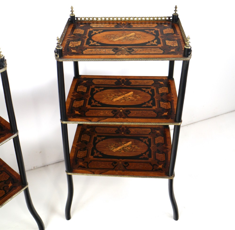A pair of 19th-century French three-tier etageres featuring inlaid wood marquetry designs, ebonised legs, and pierced brass galleries on top. View XVIII