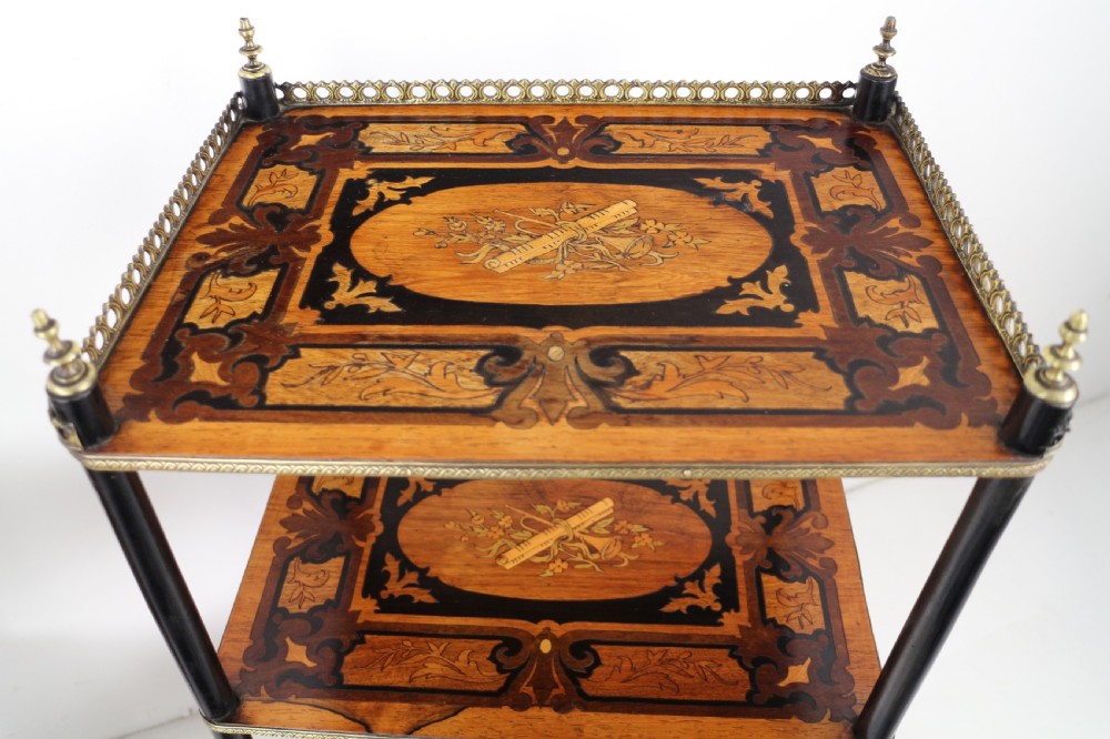 A pair of 19th-century French three-tier etageres featuring inlaid wood marquetry designs, ebonised legs, and pierced brass galleries on top. View XX