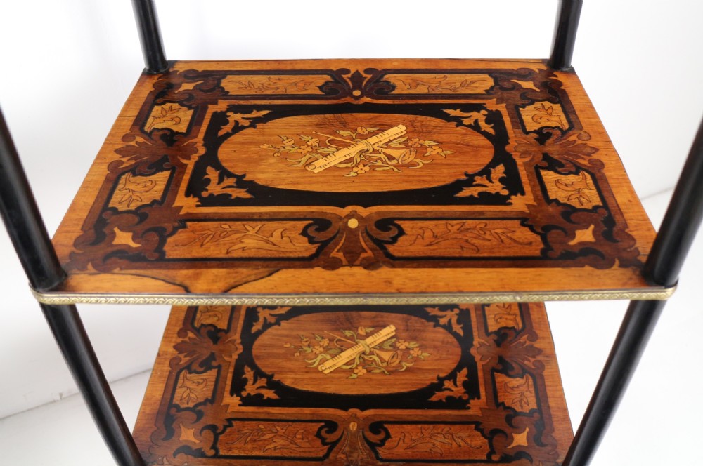 A pair of 19th-century French three-tier etageres featuring inlaid wood marquetry designs, ebonised legs, and pierced brass galleries on top. View XXI