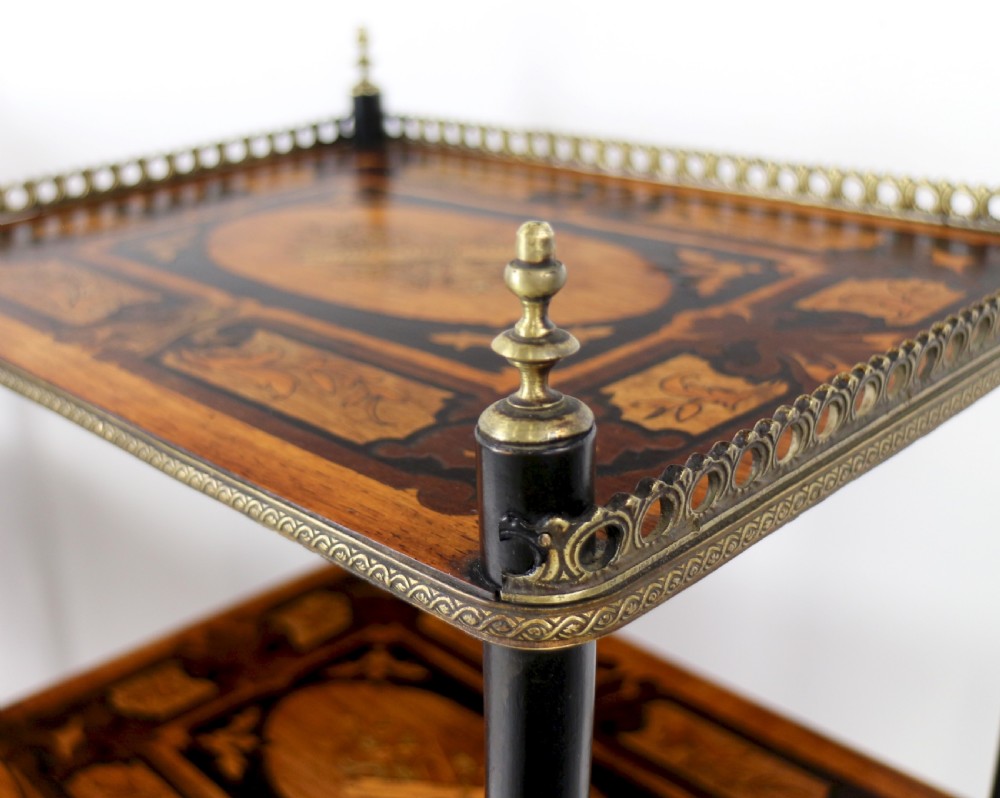 A pair of 19th-century French three-tier etageres featuring inlaid wood marquetry designs, ebonised legs, and pierced brass galleries on top. View XXVI