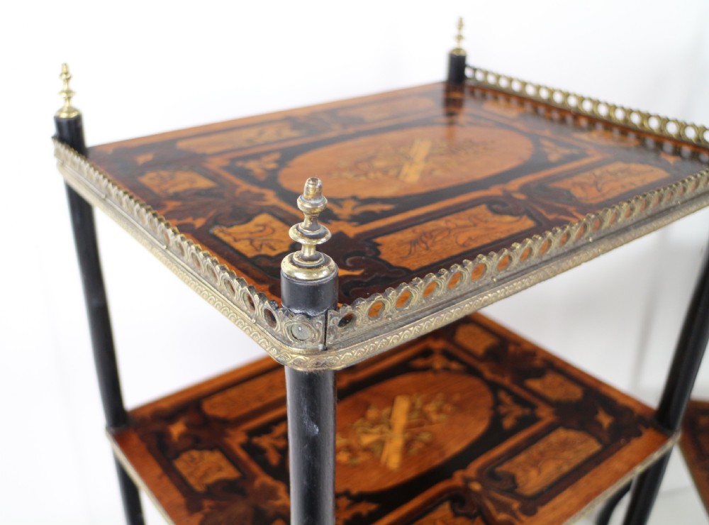 A pair of 19th-century French three-tier etageres featuring inlaid wood marquetry designs, ebonised legs, and pierced brass galleries on top. View XXVIII