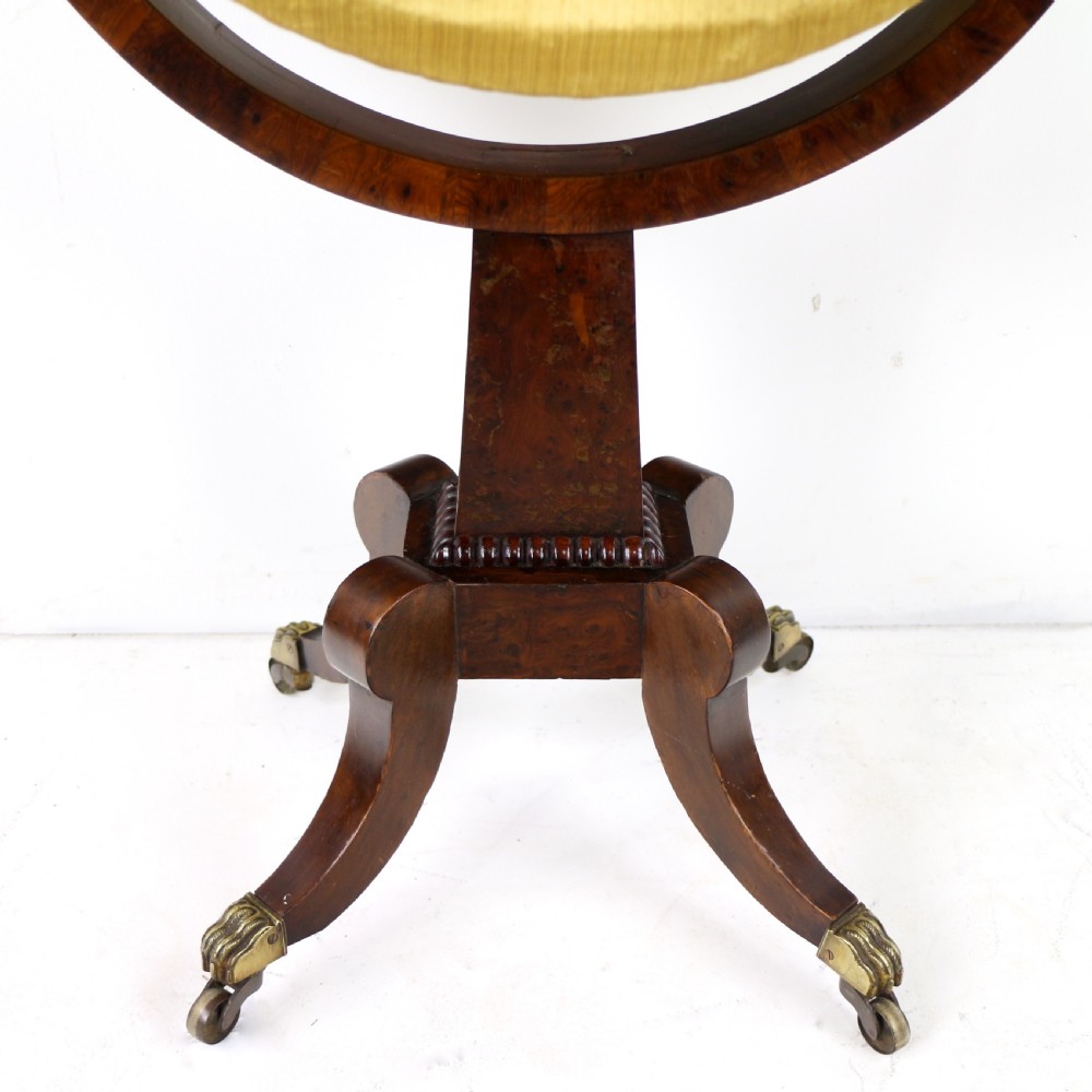 An Irish Regency drop-leaf work table featuring burr yew veneer, a single drawer, a yellow pleated fabric work well, and a quadruped pedestal base with brass castors. View XIII