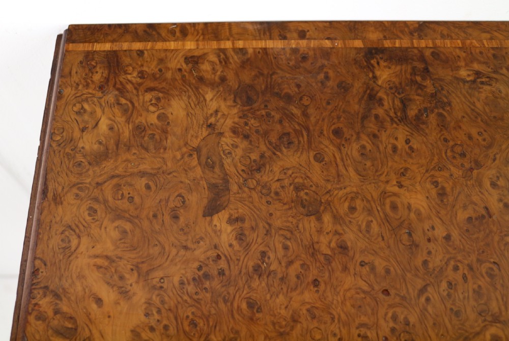 An Irish Regency drop-leaf work table featuring burr yew veneer, a single drawer, a yellow pleated fabric work well, and a quadruped pedestal base with brass castors. View XXIV