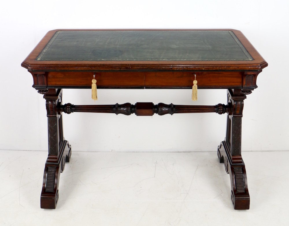 A Late Regency Neoclassical dark mahogany library table featuring a green leather inset writing surface, carved end supports with anthemion motifs, and frieze drawers with keys. View III