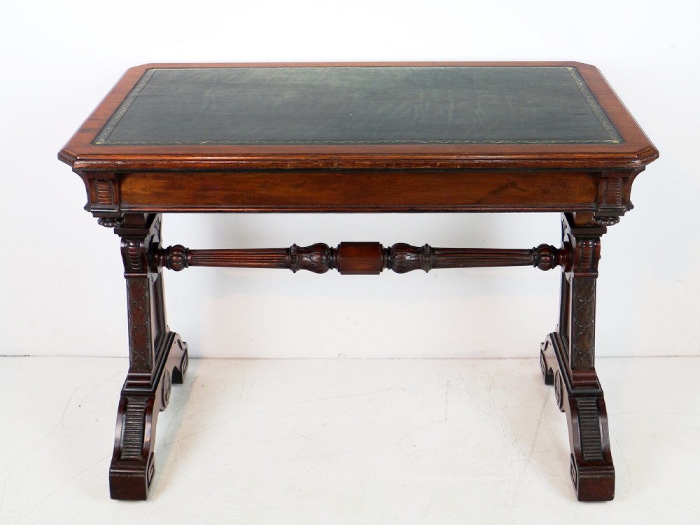 A Late Regency Neoclassical dark mahogany library table featuring a green leather inset writing surface, carved end supports with anthemion motifs, and frieze drawers with keys. View XIII