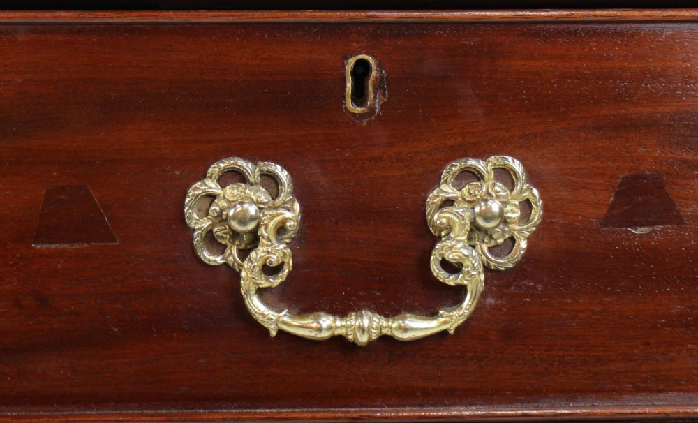 A dark mahogany kneehole library desk featuring multiple drawers with brass drop handles and panelled sides. View XII