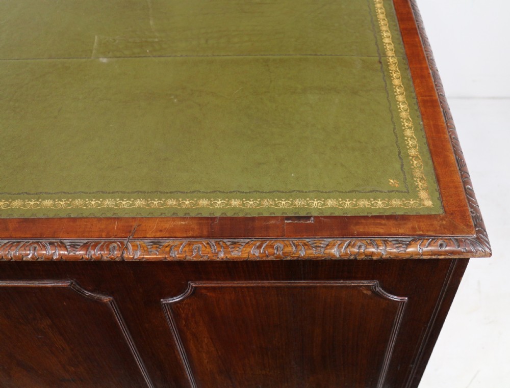 A dark mahogany kneehole library desk featuring multiple drawers with brass drop handles and panelled sides. View XVIII