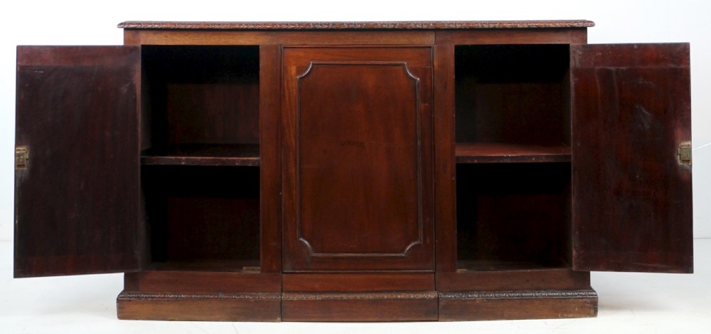 A dark mahogany kneehole library desk featuring multiple drawers with brass drop handles and panelled sides. View XXV