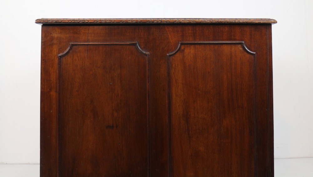 A dark mahogany kneehole library desk featuring multiple drawers with brass drop handles and panelled sides. View XXVI