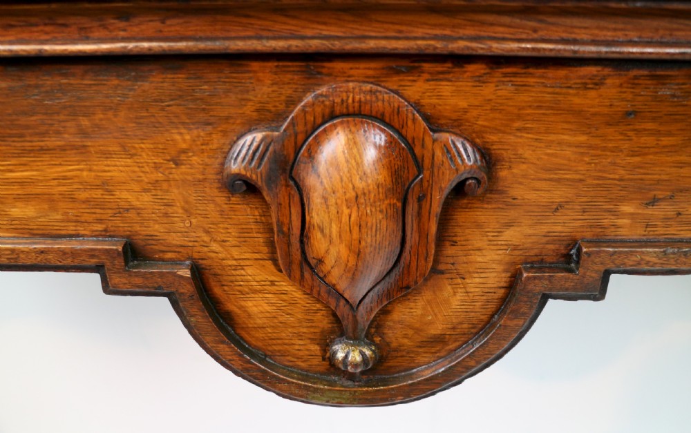 An antique William IV oak hall table featuring carved cabriole front legs and a central carved apron accent. View V