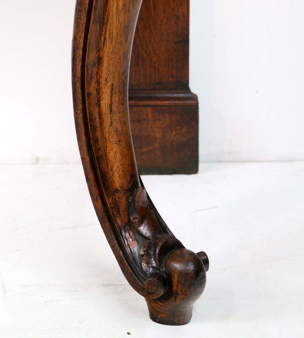 An antique William IV oak hall table featuring carved cabriole front legs and a central carved apron accent. View XIII