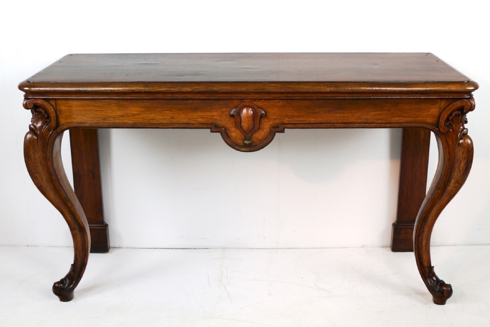 An antique William IV oak hall table featuring carved cabriole front legs and a central carved apron accent. View XV