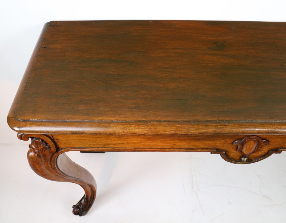 An antique William IV oak hall table featuring carved cabriole front legs and a central carved apron accent. View XX