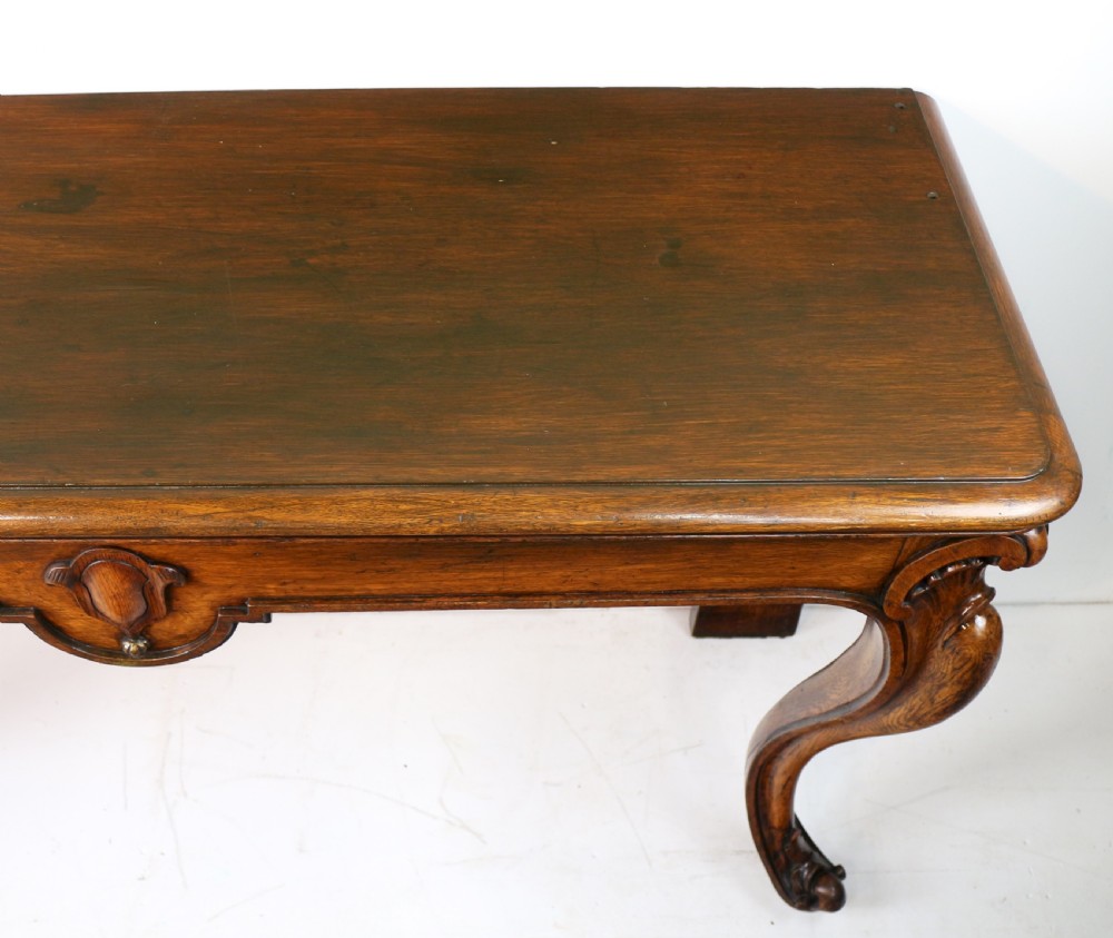An antique William IV oak hall table featuring carved cabriole front legs and a central carved apron accent. View XXI