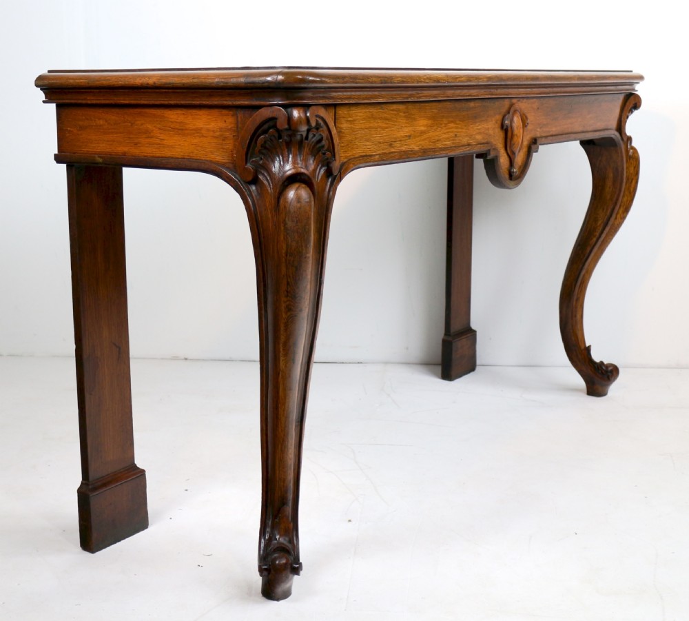 An antique William IV oak hall table featuring carved cabriole front legs and a central carved apron accent. View XXIII