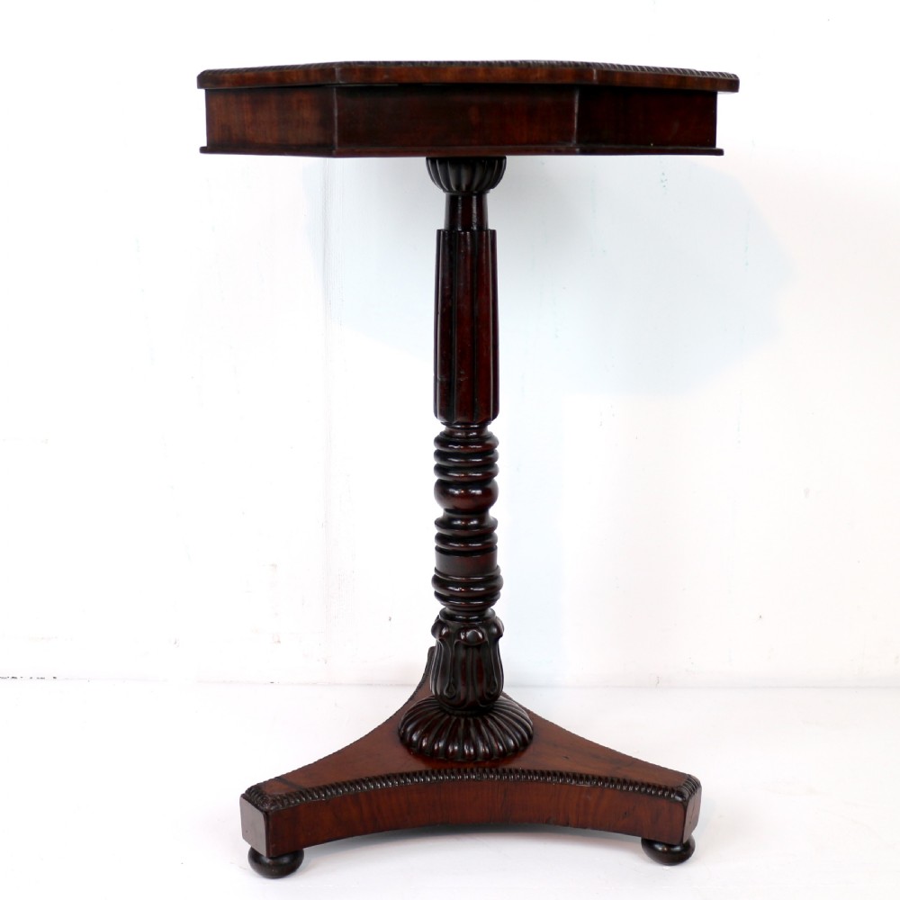 An octagonal Regency mahogany side table featuring a geometric star-patterned specimen marble top supported by a reeded column and triform base. View II