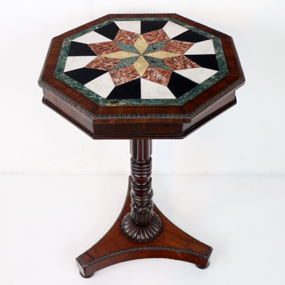 An octagonal Regency mahogany side table featuring a geometric star-patterned specimen marble top supported by a reeded column and triform base. View V