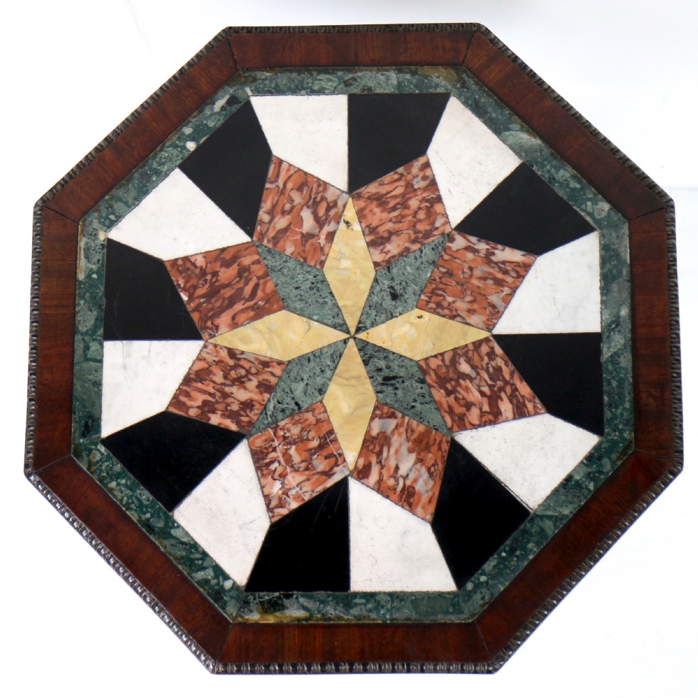 An octagonal Regency mahogany side table featuring a geometric star-patterned specimen marble top supported by a reeded column and triform base. View VI