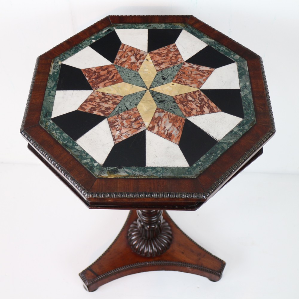 An octagonal Regency mahogany side table featuring a geometric star-patterned specimen marble top supported by a reeded column and triform base. View VII