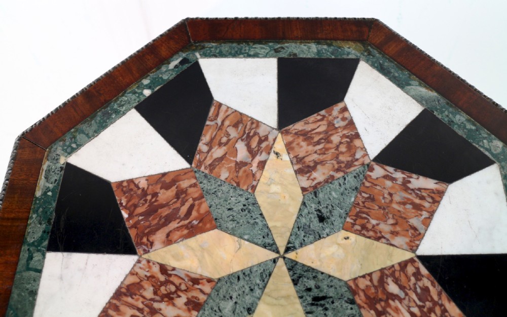 An octagonal Regency mahogany side table featuring a geometric star-patterned specimen marble top supported by a reeded column and triform base. View VIII