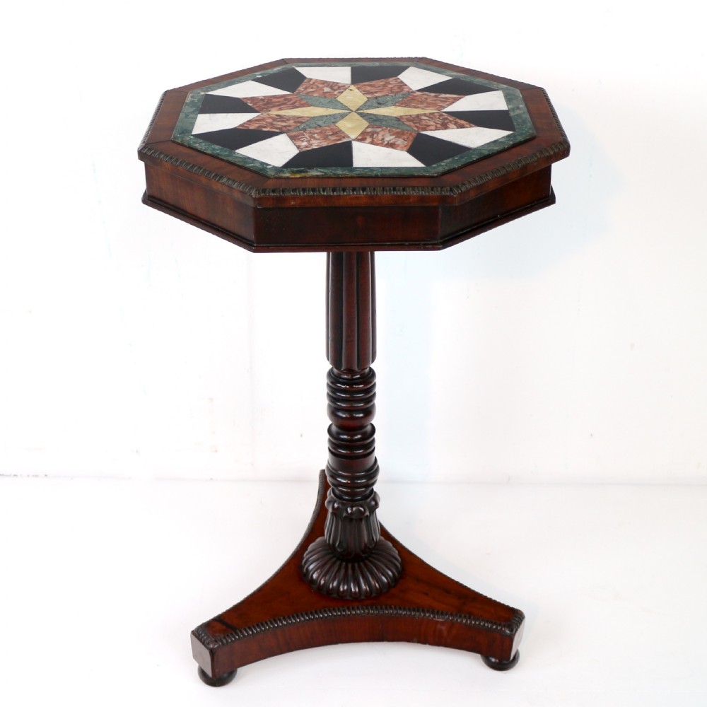 An octagonal Regency mahogany side table featuring a geometric star-patterned specimen marble top supported by a reeded column and triform base. View X