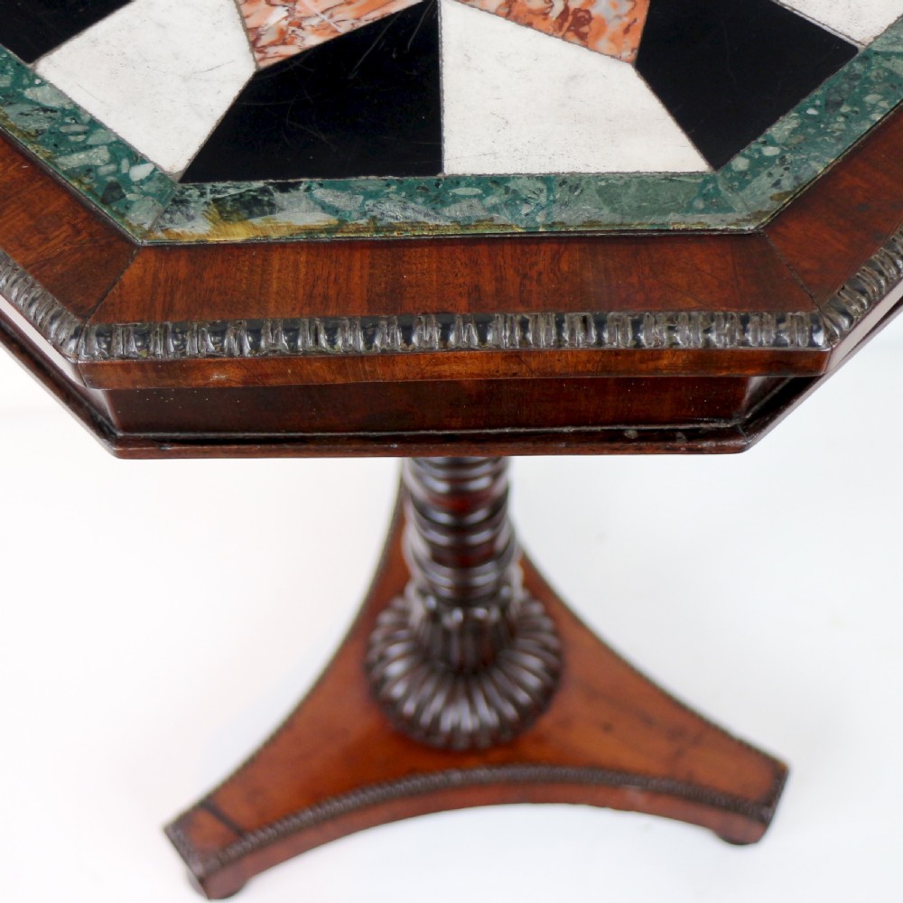 An octagonal Regency mahogany side table featuring a geometric star-patterned specimen marble top supported by a reeded column and triform base. View XV