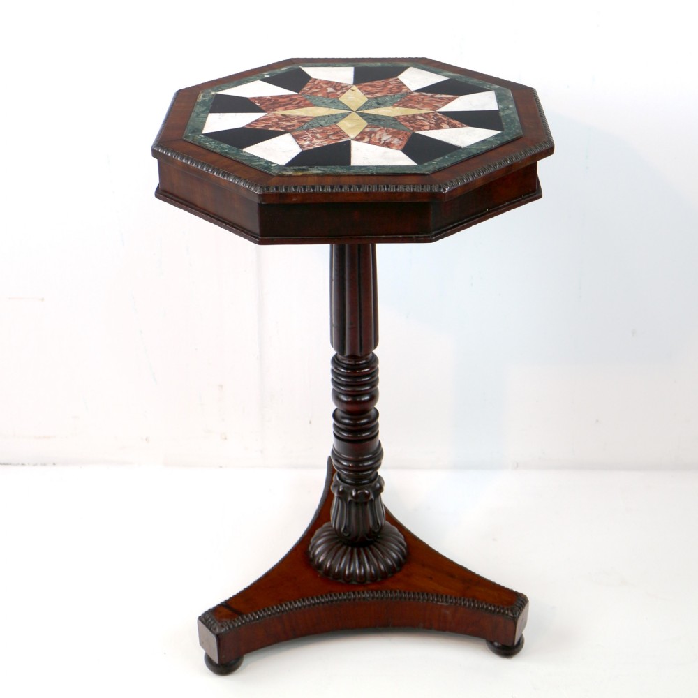 An octagonal Regency mahogany side table featuring a geometric star-patterned specimen marble top supported by a reeded column and triform base. View XVI