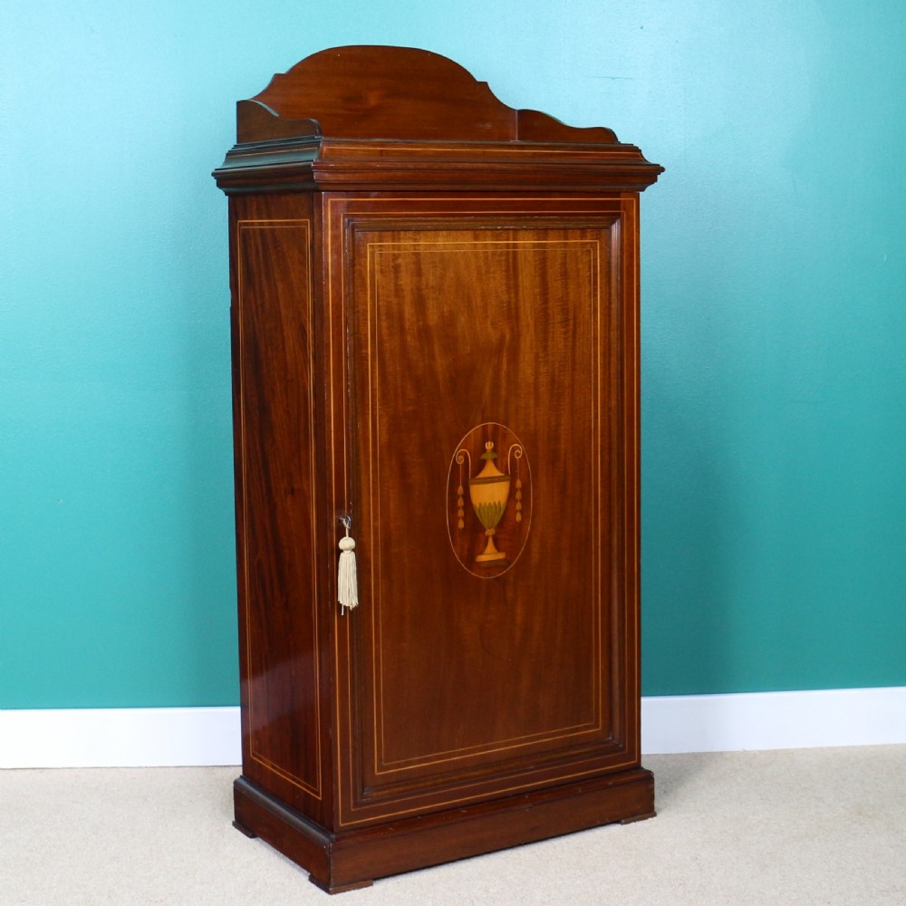 A Victorian mahogany music side cabinet featuring satinwood stringing, a central urn marquetry medallion on the door, and a shaped gallery top. View III