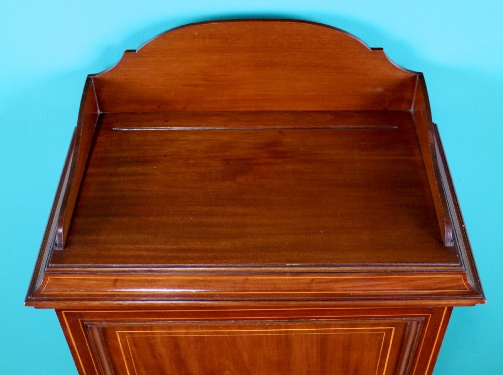 A Victorian mahogany music side cabinet featuring satinwood stringing, a central urn marquetry medallion on the door, and a shaped gallery top. View V