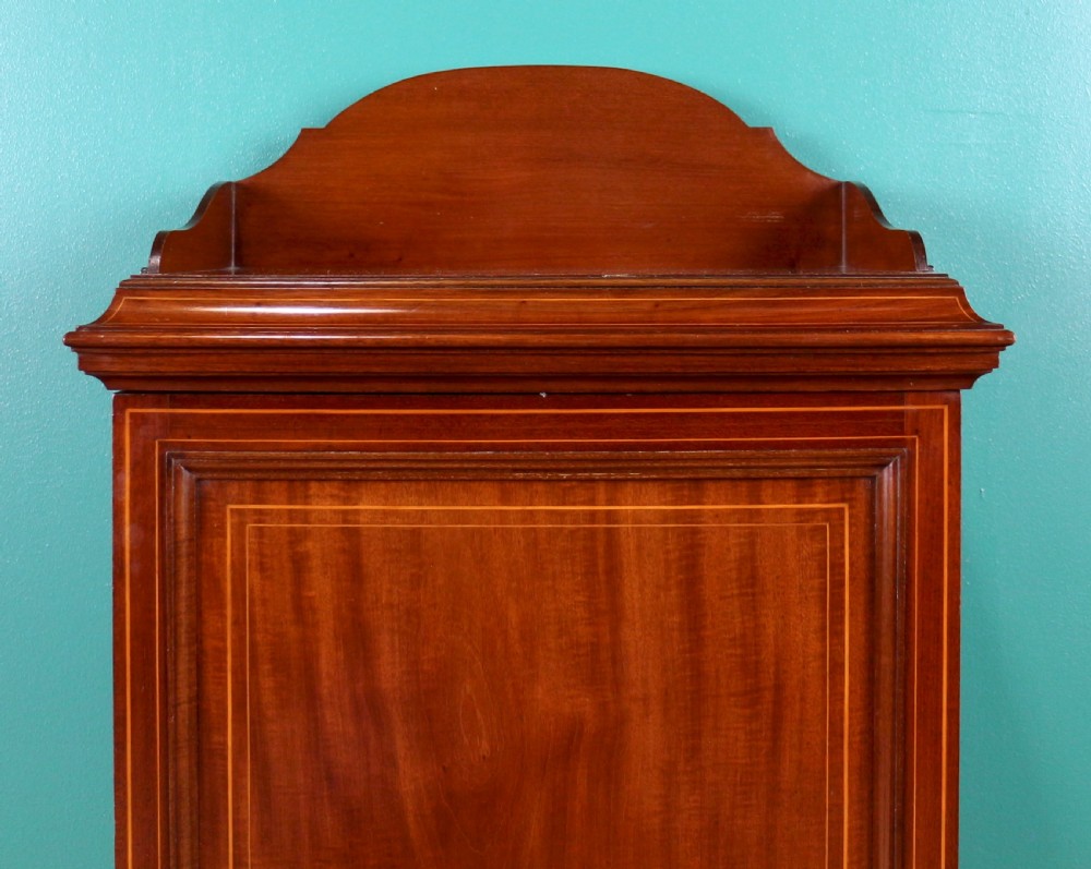 A Victorian mahogany music side cabinet featuring satinwood stringing, a central urn marquetry medallion on the door, and a shaped gallery top. View VI