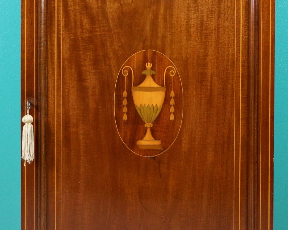 A Victorian mahogany music side cabinet featuring satinwood stringing, a central urn marquetry medallion on the door, and a shaped gallery top. View VIII